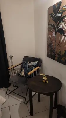 a living room with a chair and a table at BEACH APPART in Nice