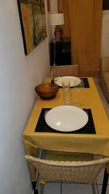 a table with two plates and glasses on top of it at BEACH APPART in Nice