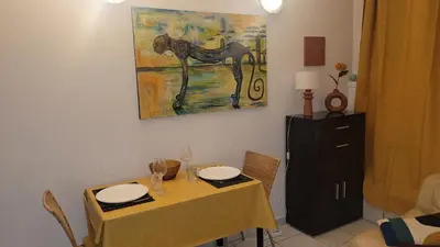 a dining room with a table and a painting of a horse at BEACH APPART in Nice