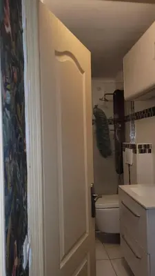 a bathroom with a toilet and a sink and a door at BEACH APPART in Nice