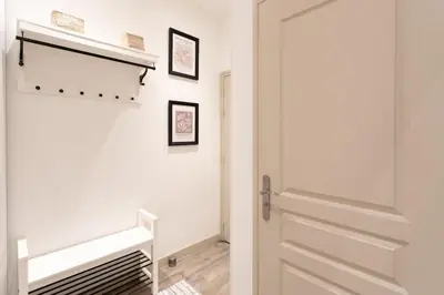 a white hallway with a door and a staircase at #44 1 BDR Flat Cap AC balcony 5mins walk to beach in Nice