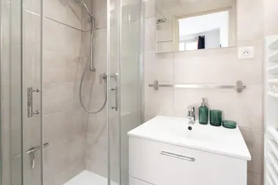 a white bathroom with a shower and a sink at #44 1 BDR Flat Cap AC balcony 5mins walk to beach in Nice