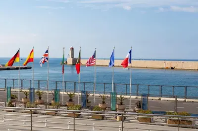 a row of flags inront of the water at #44 1 BDR Flat Cap AC balcony 5mins walk to beach in Nice