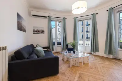a living room with a couch and a table at FEEL HOME - FOCH 28 in Nice