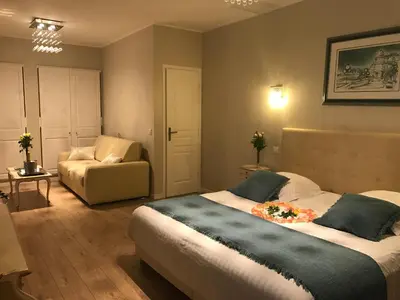 a bedroom with a large bed and a couch at Villa Kilauea B&B in Nice