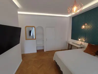 a bedroom with a white bed and a mirror at Boutique Studio 1 in Nice