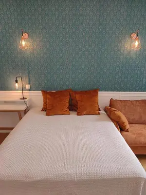 a bedroom with a white bed and a couch at Boutique Studio 1 in Nice