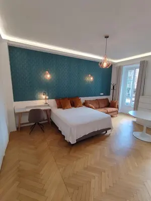 a bedroom with a bed and a green wall at Boutique Studio 1 in Nice