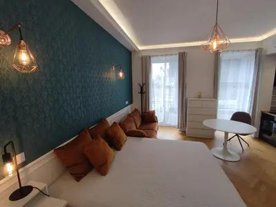 a living room with a bed and a couch at Boutique Studio 1 in Nice