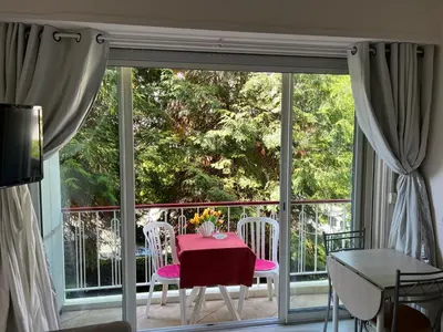 a room with a table and chairs on a balcony at Cros de Cagnes, apartment with the Best Location in Cagnes-sur-Mer