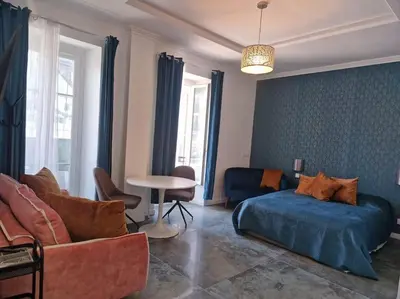 a living room with a couch and a bed and a table at Boutique Studio 2 in Nice