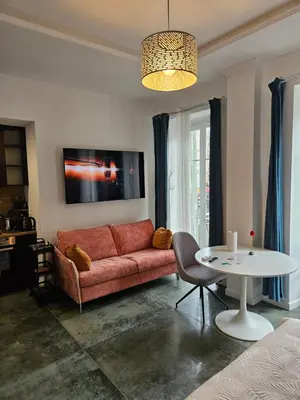 a living room with a red couch and a table at Boutique Studio 2 in Nice