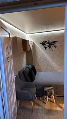a living room with a couch and a table at Chalet dans les arbres in Nice