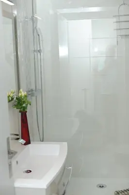 a white bathroom with a toilet and a shower at L'Azur Promenade in Nice