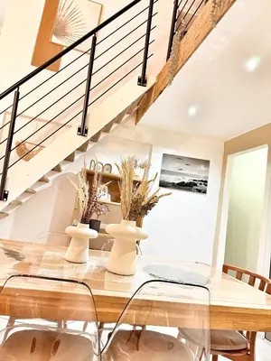 a dining room with a table and chairs and a staircase at Spacious Loft, Duplex, Old Town, 3 bedrooms - EASY CHECK-IN in Nice