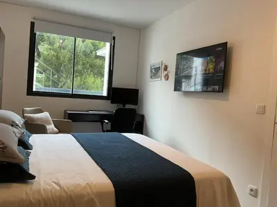 a bedroom with a bed and a desk and a window at Luxury Villa with Pool & Sea View-10 Minutes from Monaco in Èze