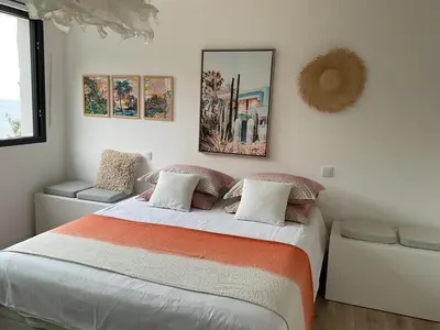 a bedroom with a large bed and some pictures on the wall at Luxury Villa with Pool & Sea View-10 Minutes from Monaco in Èze