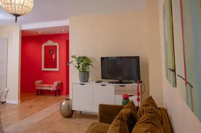 a living room with a couch and a flat screen tv at Large magnificent terrace (40 sq.m) in Nice