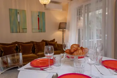 a table with a plate of bread and wine glasses at Large magnificent terrace (40 sq.m) in Nice