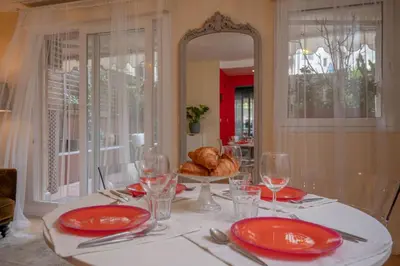 a table with red plates and a basket of bread at Large magnificent terrace (40 sq.m) in Nice