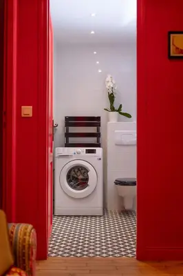 a bathroom with a washing machine and a toilet at Large magnificent terrace (40 sq.m) in Nice