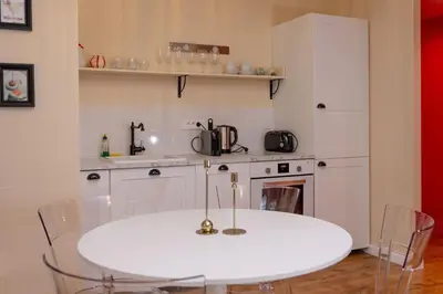a kitchen with a white table and chairs and a stove at Large magnificent terrace (40 sq.m) in Nice