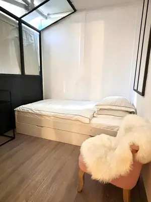 a small room with a bed and a stool at Large magnificent terrace (40 sq.m) in Nice