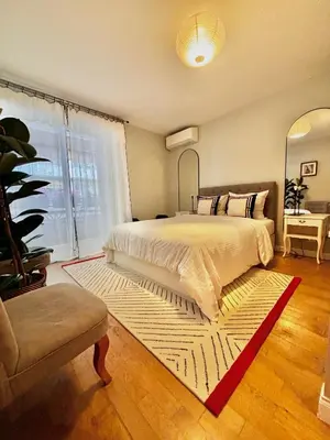 a bedroom with a large bed and a large window at Large magnificent terrace (40 sq.m) in Nice