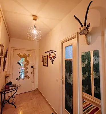 a hallway with a door with a antelope head on the wall at Central Studio in Nice