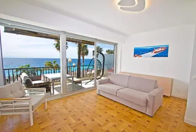 a living room with a view of the ocean at Luxury sea front suite Promenade in Nice