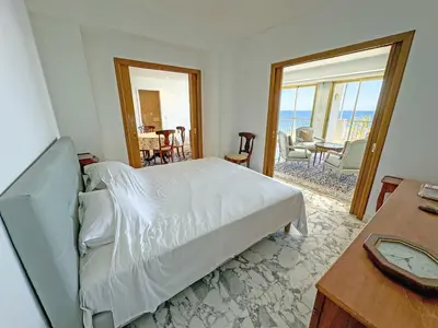 a bedroom with a bed and a view of the ocean at Panoramic Sea View Promenade in Nice
