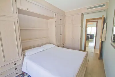 a bedroom with a white bed and cabinets at Panoramic Sea View Promenade in Nice