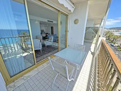 a balcony with a glass table and chairs on it at Panoramic Sea View Promenade in Nice