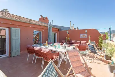 a patio with a table and chairs on a roof at #48 Suite Jean top floor terrace 5min walk sea AC in Nice