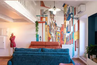a living room with a couch and a painting on the wall at #48 Suite Jean top floor terrace 5min walk sea AC in Nice