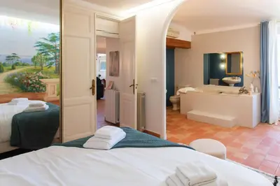 a room with two beds and a bathroom with a tub at #48 Suite Jean top floor terrace 5min walk sea AC in Nice
