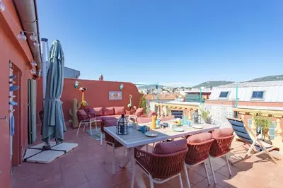 a patio with a table and chairs on a balcony at #48 Suite Jean top floor terrace 5min walk sea AC in Nice