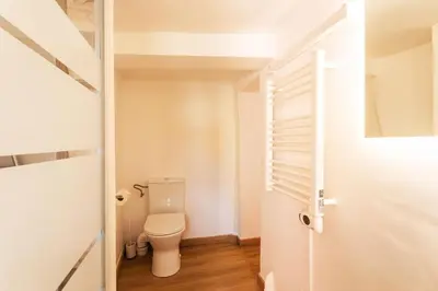 a small bathroom with a toilet and a door at THE BAY AP4371 By Riviera Holiday Homes in Villefranche-sur-Mer