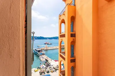 a view of a harbor from a window of a building at THE BAY AP4371 By Riviera Holiday Homes in Villefranche-sur-Mer