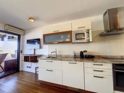 a kitchen with white cabinets and a microwave at Nestor&Jeeves - HUBLOT TERRASSE - Sea view - swimming pool in Nice
