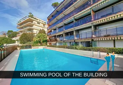 a swimming pool of the building with two people standing next to it at Nestor&Jeeves - HUBLOT TERRASSE - Sea view - swimming pool in Nice