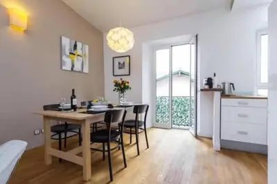 a kitchen and dining room with a table and chairs at Signature Penthouse at Villefranche, Steps to Beach, Limited-Time Offer in Villefranche-sur-Mer