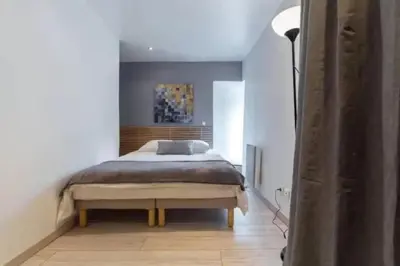 a bedroom with a bed in a white room at Signature Penthouse at Villefranche, Steps to Beach, Limited-Time Offer in Villefranche-sur-Mer