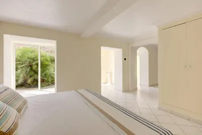 a white bedroom with a bed and a window at Mont Boron Exclusive Apartment in Villa Belle Époque in Nice