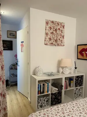 a bedroom with a bed and a book shelf at Logement privé Nice - Crémat in Nice