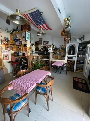 a dining room with a pink table and chairs at Logement privé Nice - Crémat in Nice