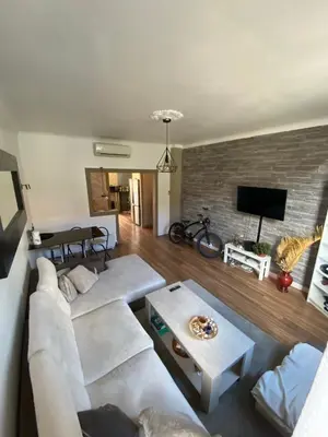 a living room with white furniture and a brick wall at 3 P 75 M2 Centre de nice in Nice