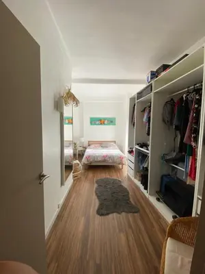 a room with a hallway with a bed and a hard wood floor at 3 P 75 M2 Centre de nice in Nice