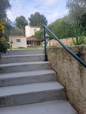 a set of stairs with a metal rail at Maison du bonheur calme et verdure in Nice