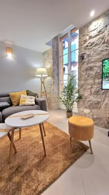 a living room with a couch and a table at T3 duplex cosy & calme au port - Tram in Nice